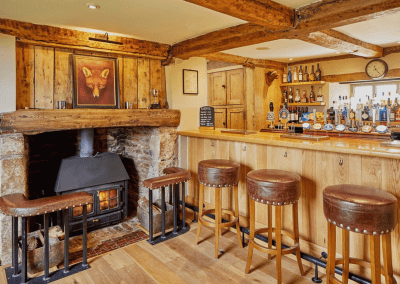 A Grade II listed country pub interior, featuring bespoke dining chairs, tub chairs, and fixed seating made by Jameson Seating.