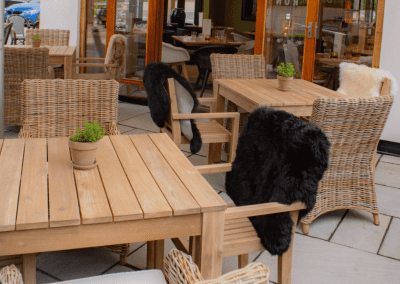 Pub Interior featuring bespoke bar stools, dining chairs, tables, curtains, and cushions to create a cricket-inspired atmosphere.