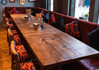 Bespoke restaurant seating in vibrant colours and bold fabrics for an Argentinian-inspired restaurant with a lively atmosphere.