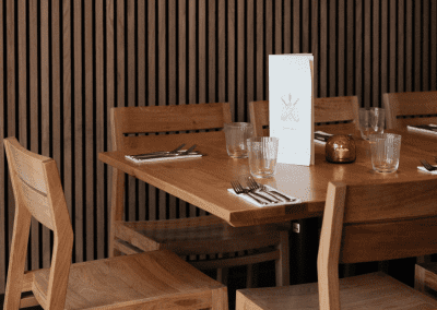 Pub Interior featuring bespoke bar stools, dining chairs, tables, curtains, and cushions to create a cricket-inspired atmosphere.