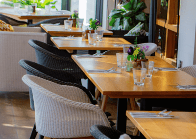 Pub Interior featuring bespoke bar stools, dining chairs, tables, curtains, and cushions to create a cricket-inspired atmosphere.