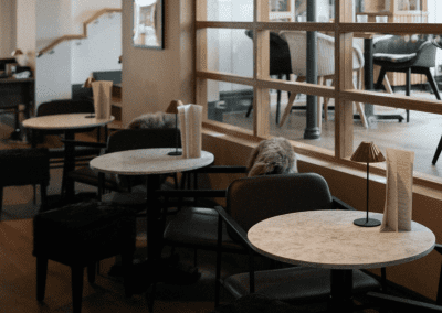 Pub Interior featuring bespoke bar stools, dining chairs, tables, curtains, and cushions to create a cricket-inspired atmosphere.