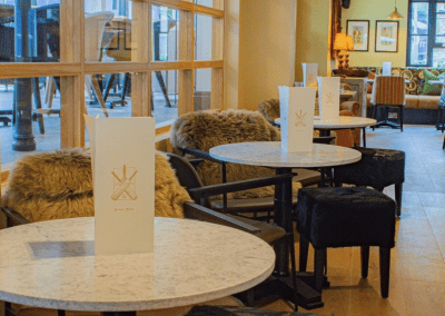 Pub Interior featuring bespoke bar stools, dining chairs, tables, curtains, and cushions to create a cricket-inspired atmosphere.