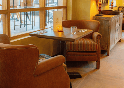 Pub Interior featuring bespoke bar stools, dining chairs, tables, curtains, and cushions to create a cricket-inspired atmosphere.