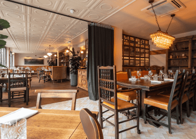 Interior of a stylish public house, featuring contemporary partition curtains for separate dining and gaming room spaces, and café curtains for a warm and contemporary feel.