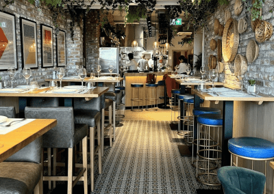 Bespoke bar and restaurant furniture for Botana Jersey, including dining chairs, bar stools and tables, featuring stylish Mediterranean-inspired design.