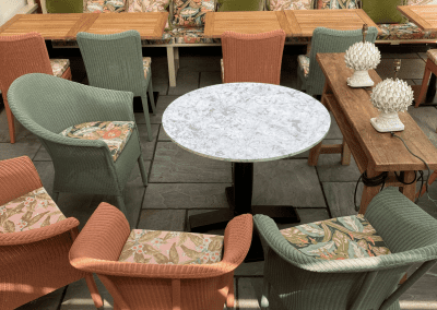 Pub Interior featuring bespoke bar stools, dining chairs, tables, curtains, and cushions to create a cricket-inspired atmosphere.