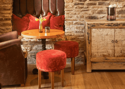 A Grade II listed country pub interior for The Full Moon Inn Somerset, featuring bespoke dining chairs, tub chairs, and fixed seating made by Jameson Seating.
