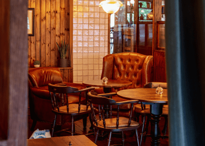 Interior of Apollo Arms Clapham, featuring contemporary partition curtains for separate dining and gaming room spaces, and café curtains for a warm and contemporary feel.