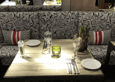 A stylish country pub interior for The Orange Tree Solihull, featuring bespoke dining chairs, tub chairs, and fixed seating made by Jameson Seating.