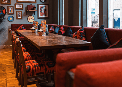 Bespoke restaurant seating in vibrant colours and bold fabrics for Sonrisa Leicester, an Argentinian-inspired restaurant with a lively atmosphere.