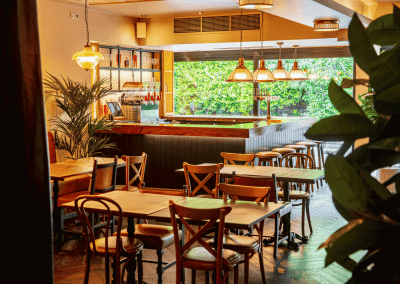 Interior of Apollo Arms Clapham, featuring contemporary partition curtains for separate dining and gaming room spaces, and café curtains for a warm and contemporary feel.