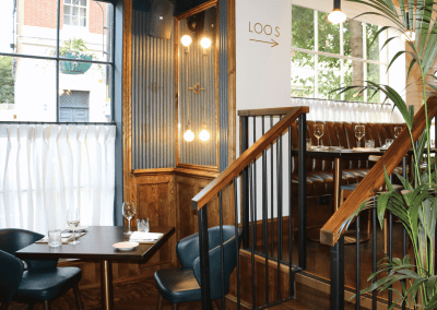 Bespoke eyelet screen curtains for gastropubs, creating a stylish and private restaurant space.