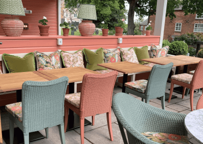 Pub Interior featuring bespoke bar stools, dining chairs, tables, curtains, and cushions to create a cricket-inspired atmosphere.