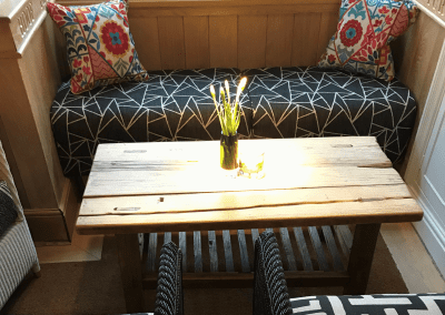 A stylish country pub interior, featuring bespoke dining chairs, tub chairs, and fixed seating made by Jameson Seating.
