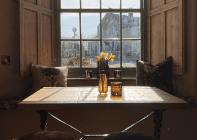 A Grade II listed country pub interior, featuring bespoke dining chairs, tub chairs, and fixed seating made by Jameson Seating.