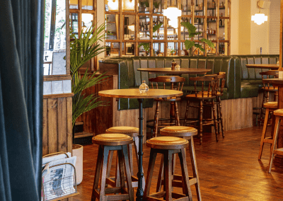 Interior of Apollo Arms Clapham, featuring contemporary partition curtains for separate dining and gaming room spaces, and café curtains for a warm and contemporary feel.
