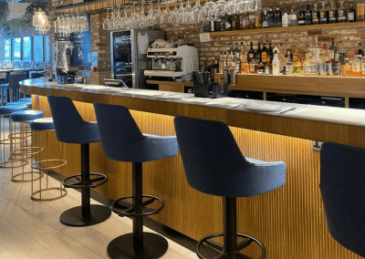 Bespoke bar and restaurant furniture including dining chairs, bar stools and tables, featuring stylish Mediterranean-inspired design.