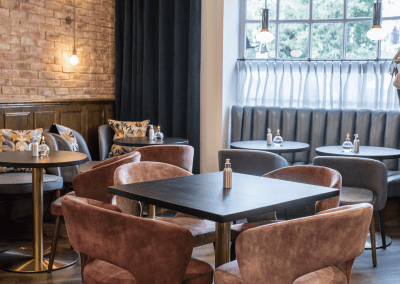 Bespoke eyelet screen curtains for gastropubs, creating a stylish and private restaurant space.