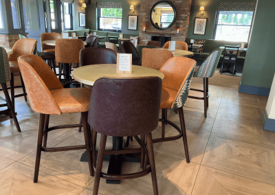 Pub Interior featuring bespoke bar stools, dining chairs, tables, curtains, and cushions to create a cricket-inspired atmosphere.