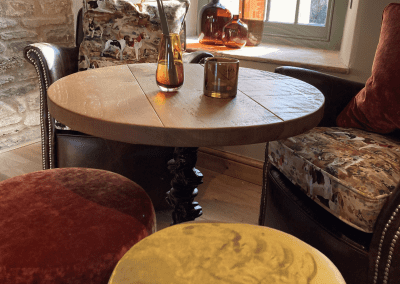 A Grade II listed country pub interior, featuring bespoke dining chairs, tub chairs, and fixed seating made by Jameson Seating.