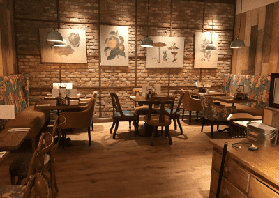 Bespoke furniture and refurbished & reupholstered furniture for The Curator Heathrow, an airport restaurant and lounge with a stylish and modern interior.
