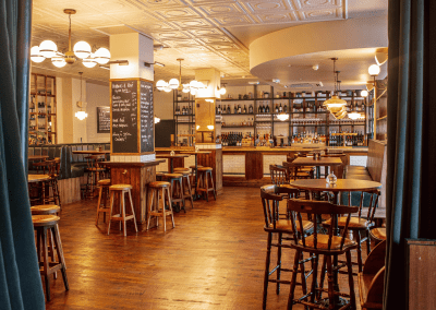 Interior of Apollo Arms Clapham, featuring contemporary partition curtains for separate dining and gaming room spaces, and café curtains for a warm and contemporary feel.