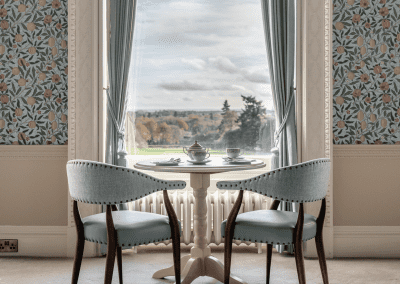 Elegant soft furnishings at Heythrop Park, Oxfordshire, featuring bespoke curtains and accent pieces, blending period charm with refined comfort.