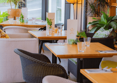 Interior of The Tap & Run pub in Upper Broughton, featuring bespoke bar stools, dining chairs, tables, curtains, and cushions to create a cricket-inspired atmosphere.
