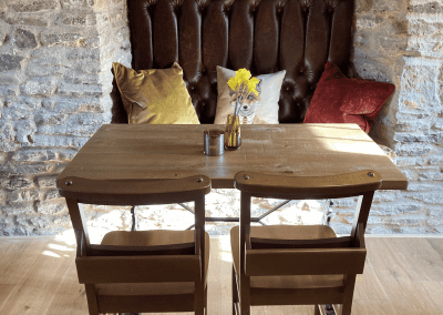 A Grade II listed country pub interior, featuring bespoke dining chairs, tub chairs, and fixed seating made by Jameson Seating.