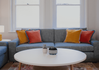 Refurbished common room at Cheltenham Ladies College, featuring durable compact sofas, tub chairs, and dining furniture in uplifting tones.