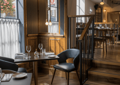 Bespoke eyelet screen curtains for gastropubs, creating a stylish and private restaurant space.