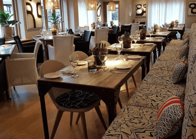 A stylish country pub interior, featuring bespoke dining chairs, tub chairs, and fixed seating made by Jameson Seating.