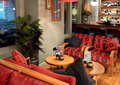 Bespoke restaurant seating in vibrant colours and bold fabrics for an Argentinian-inspired restaurant with a lively atmosphere.