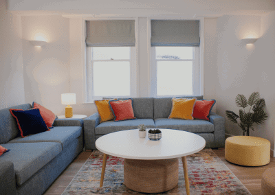 Refurbished common room at Cheltenham Ladies College, featuring durable compact sofas, tub chairs, and dining furniture in uplifting tones.