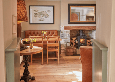 A Grade II listed country pub interior, featuring bespoke dining chairs, tub chairs, and fixed seating made by Jameson Seating.