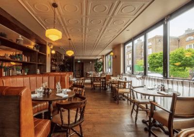 Interior of a stylish public house, featuring contemporary partition curtains for separate dining and gaming room spaces, and café curtains for a warm and contemporary feel.
