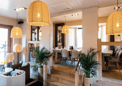 A stylish country pub interior, featuring bespoke dining chairs, tub chairs, and fixed seating made by Jameson Seating.