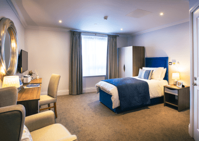 Interior picture of a residential care home, featuring calming and comfortable furniture in a range of rooms, to support senior living.