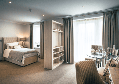 Interior picture of a residential care home, featuring calming and comfortable furniture in a range of rooms, to support senior living.
