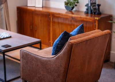 Interior picture of a residential care home, featuring calming and comfortable furniture in a range of rooms, to support senior living.