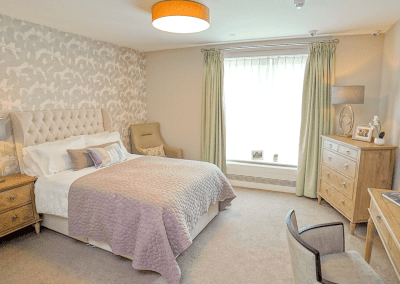 Interior picture of a residential care home, featuring calming and comfortable furniture in a range of rooms, to support senior living.
