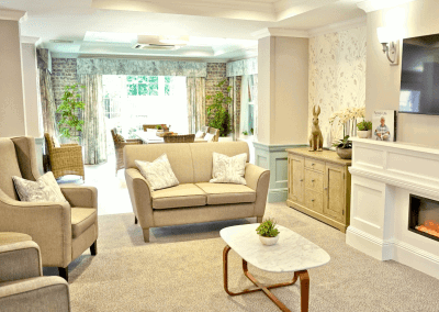 Interior picture of a residential care home, featuring calming and comfortable furniture in a range of rooms, to support senior living.