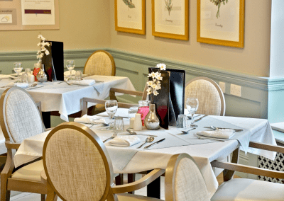 Interior picture of a residential care home, featuring calming and comfortable furniture in a range of rooms, to support senior living.