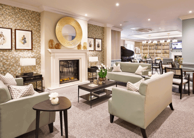 Interior picture of a residential care home, featuring calming and comfortable furniture in a range of rooms, to support senior living.