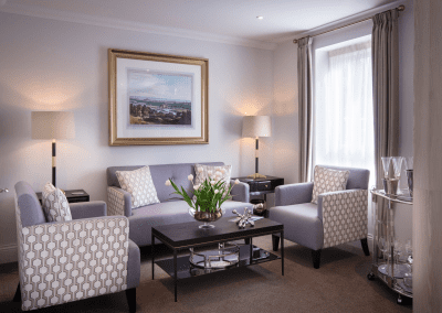 Interior picture of a residential care home, featuring calming and comfortable furniture in a range of rooms, to support senior living.