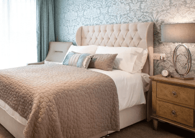 Interior picture of a residential care home, featuring calming and comfortable furniture in a range of rooms, to support senior living.