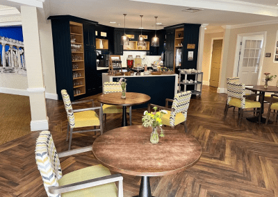 Interior picture of a residential care home, featuring calming and comfortable furniture in a range of rooms, to support senior living.