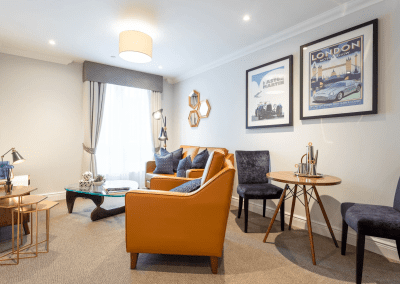 Interior picture of a residential care home, featuring calming and comfortable furniture in a range of rooms, to support senior living.