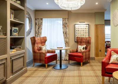 Interior picture of a residential care home, featuring calming and comfortable furniture in a range of rooms, to support senior living.